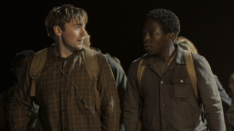 Cooper Hoffman as Raymond and David Jonsson as Pete walking together at night in The Long Walk