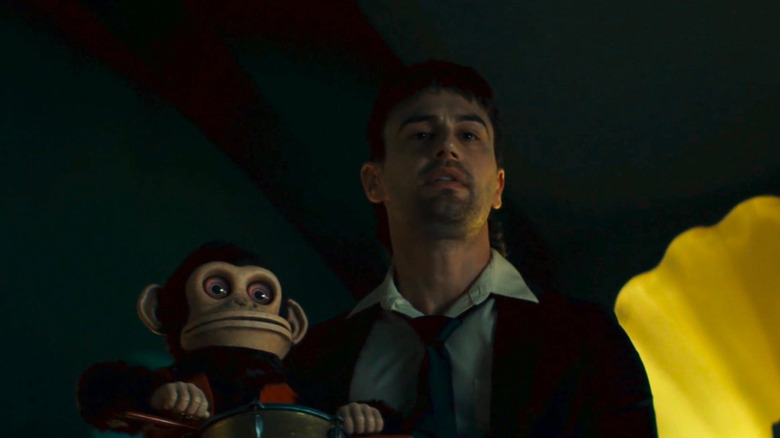 Bill holds a monkey in the monkey