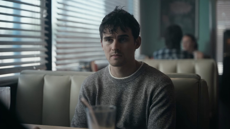 Bear sitting at a diner booth in Obsession