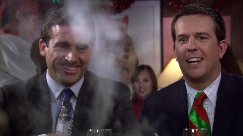Michael Scott and Andy Bernard sit at a Benihana table, watching in awe at something smoky in front of them on The Office