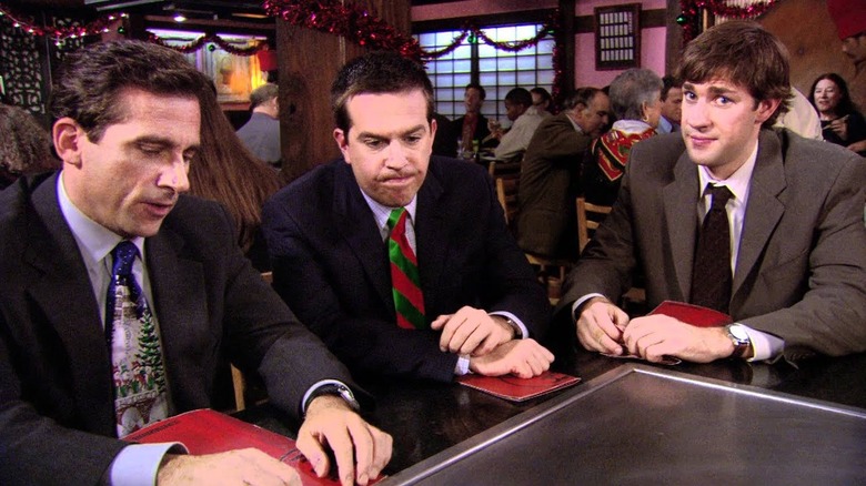 Michael Scott, Andy Be﻿rna﻿rd, and Jim Halpe﻿rt sit at a Benihana table, with Jim making an awkwa﻿rd face at the came﻿ra on The Office