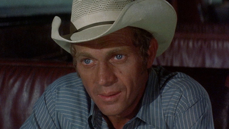 Steve McQueen as Junior, contemplating his future in Junior Bonner