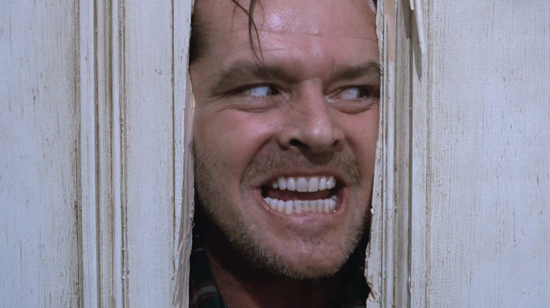 Jack Nicholson's Jack Torrance is seen looking through a hole in a door in The Shining