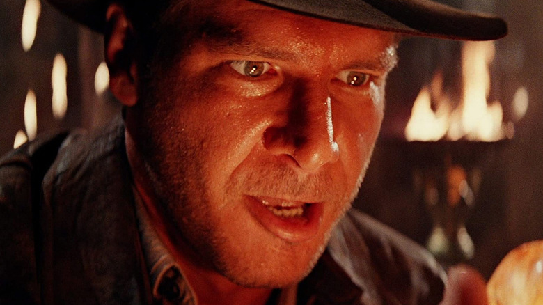 Indiana Jones holding a sacred stone in Temple of Doom