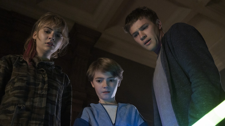 Kinsey, Bode, and Tyler look down in bewilderment in Locke & Key