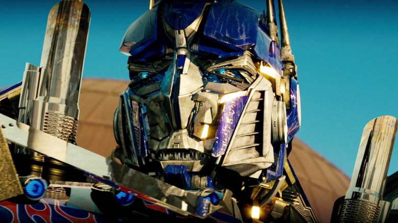 Peter Cullen as the voice of Optimus Prime glaring with purple eyes in Transformers: The Last Knight