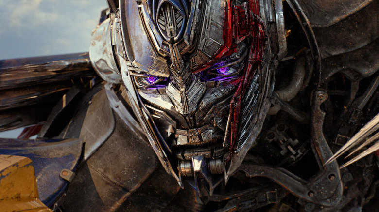 Peter Cullen as the voice of Optimus Prime glaring with purple eyes in Transformers: The Last Knight