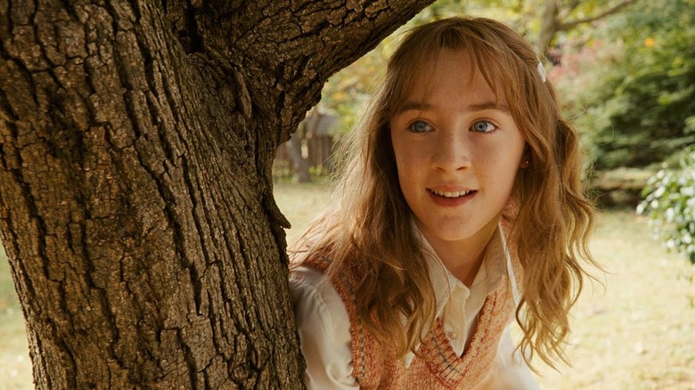 Saoirse Ronan while Susie Salmon stands behind a tree in the beautiful bones