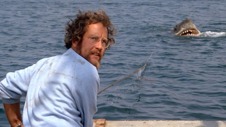 Matt Hooper looks terrified as a killer shark looms behind him in Jaws