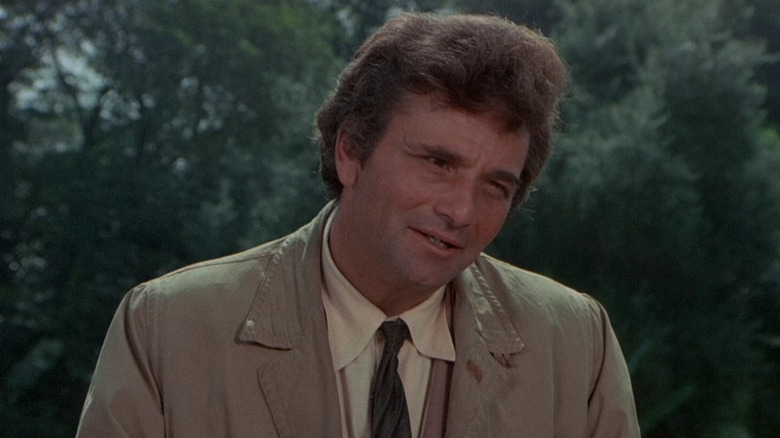 Columbo standing in front of some bushes on Columbo