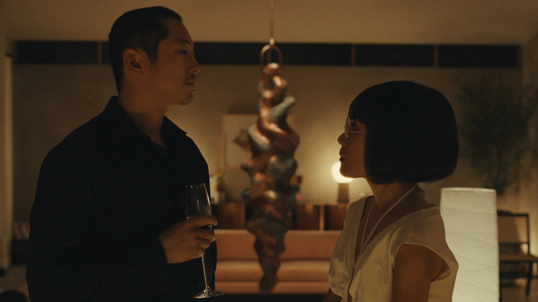Danny (Steven Yeun) and Amy (Ali Wong) consider each other in Beef.