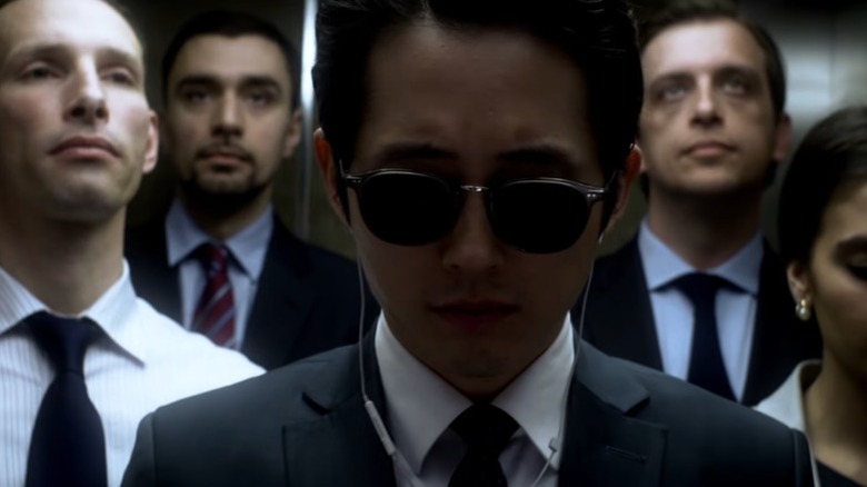 Derek (Steven Yeun) in an elevator in Mayhem.
