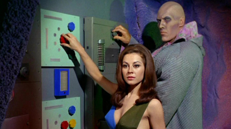Sherry Jackson as Andrea and Ted Cassidy as Ruk working on a monitor in the Star Trek episode What Are Little Girls Made Of?