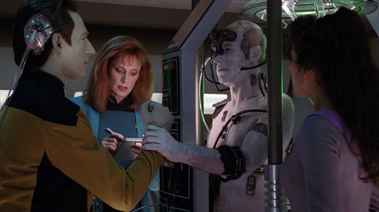 Data with a wire in his head, next to Dr. Crusher and Counselor Troi, trying to cure a Borgified Captain Picard on Star Trek: The Next Generation.