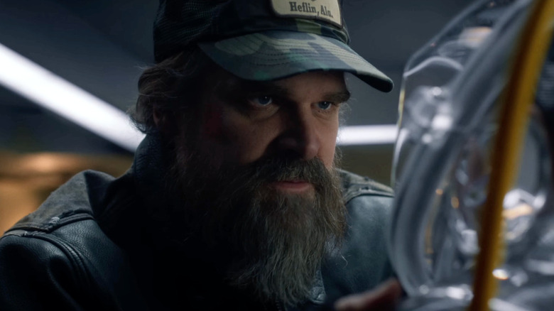 Jim Hopper (David Harbour) examines something closely in Stranger Things
