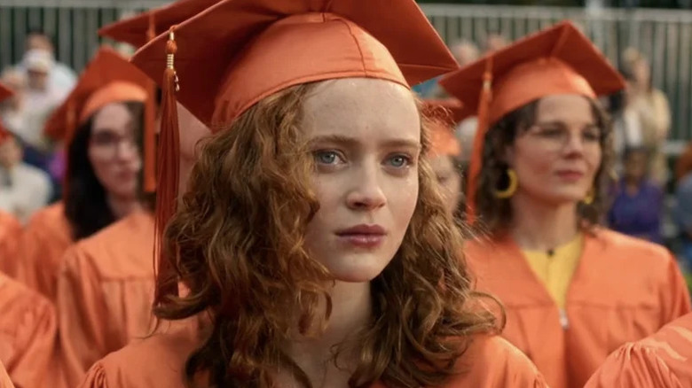 Max Mayfield (Sadie Sink) sits at her high school graduation in Stranger Things