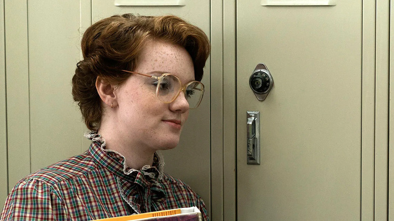 Shannon Purser as Barb standing in front of her locker in Stranger Things season 1