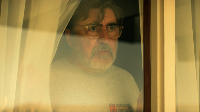 Sam (Alfred Molina) looking out of a window on "The Boroughs."