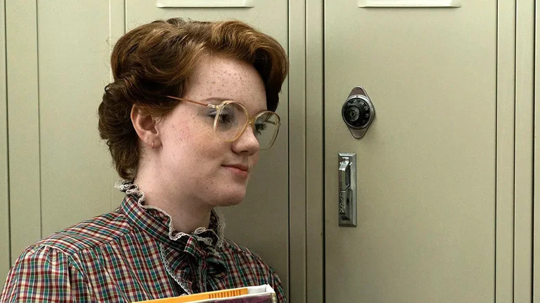 Shannon Purser's Barb stands by her locker in Stranger Things