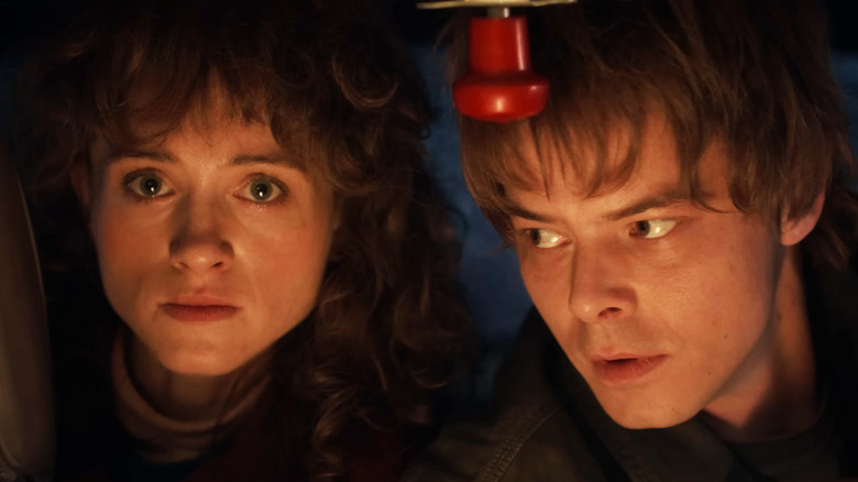 Natalia Dyer's Nancy Wheeler is seen next to Charlie Heaton's Jonathan Byers in closeup in Stranger Things