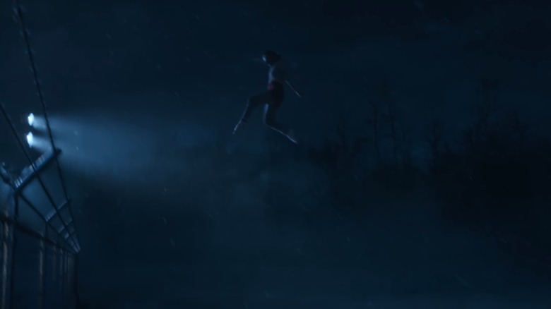 Eleven (Millie Bobby Brown) leaping over a gate in Stranger Things