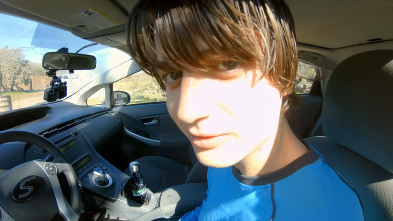 Joe Keery as Kurt Krunkle staring into a mounted dashcam in Spree