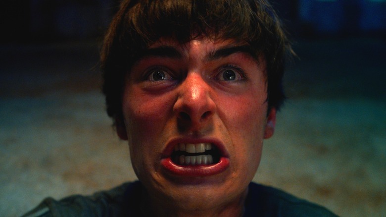 Close-up of Will Byers baring his teeth and screaming in Stranger Things