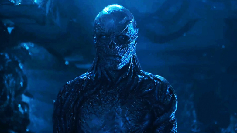 Jamie Campbell Bower's Vecna stands in the Upside Down in Stranger Things