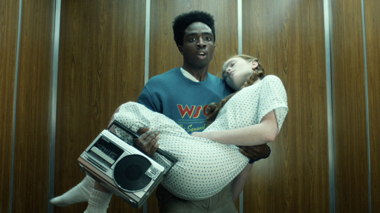 Lucas carries an unconscious Max in Stranger Things
