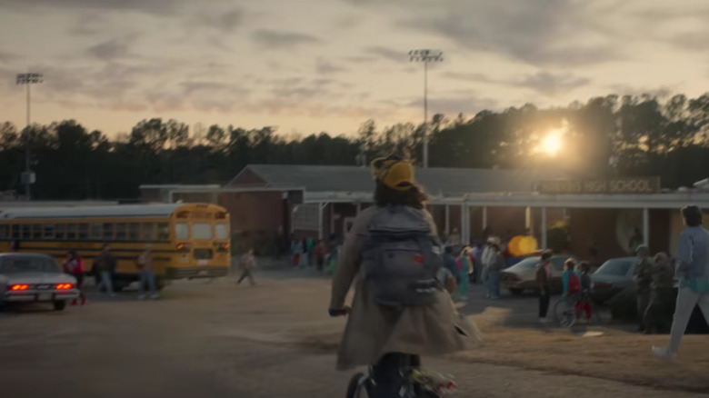 Gaten Matarazzo's Dustin riding a bike to high school on Stranger Things