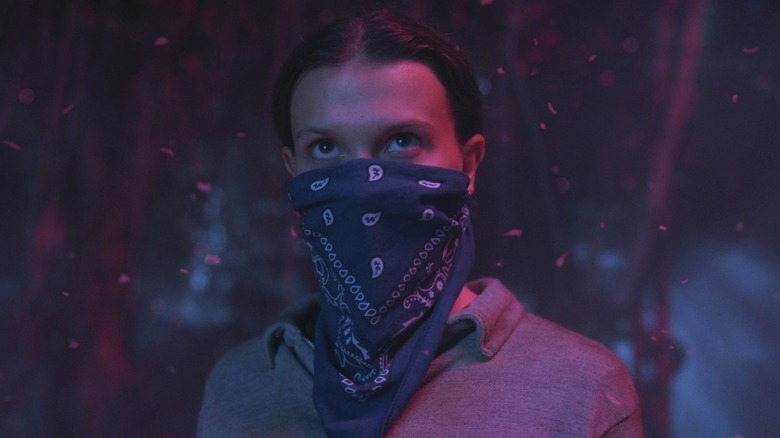 Eleven looks determined as she traverses the Upside Down in Stranger Things