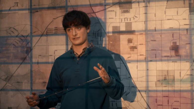 Will briefs the gang with a map in the background in Stranger Things