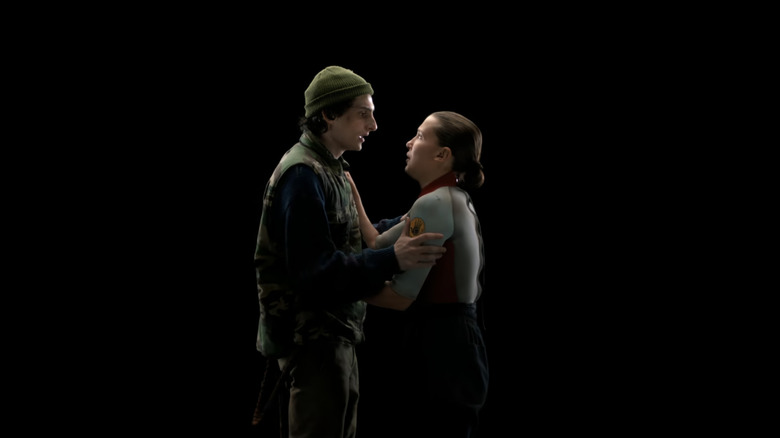 Finn Wolfhard's Mike Wheeler holds Milly Bobby Brown's Eleven in the void in Stranger Things