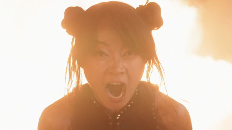 Chun-Li yells in front of a fire in Street Fighter