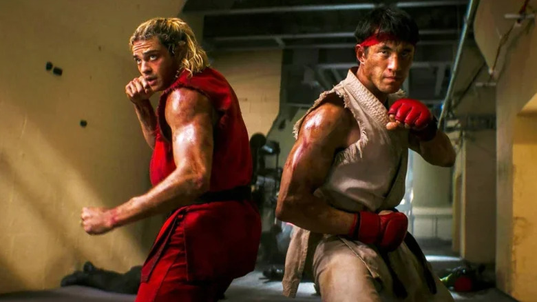 Noah Centineo as Ken standing back to back with Andrew Koji as Ryu with their fists up ready to fight in Street Fighter (2026)