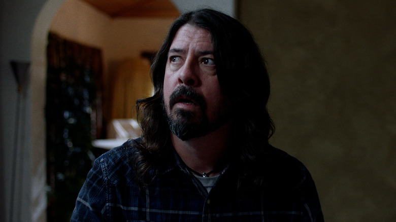 dave grohl looking to his right inside a house