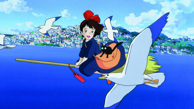 Kiki and Jiji riding on a broom by birds in Kiki's Delivery Service