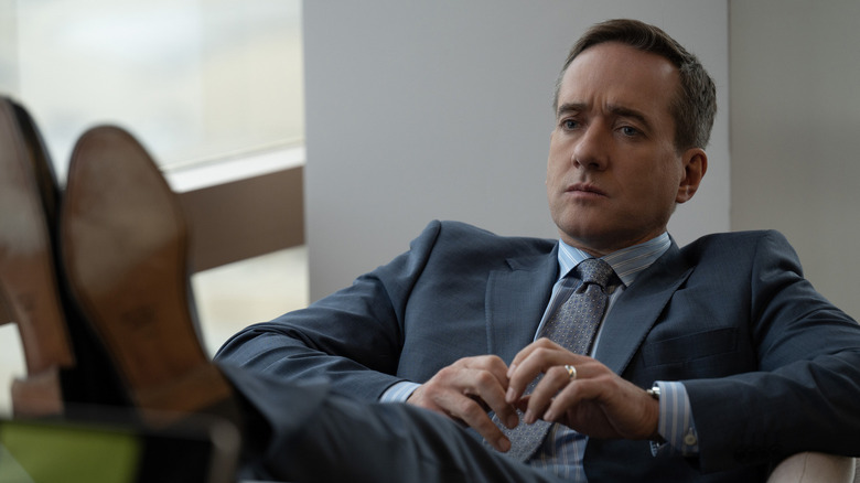 Tom with his feet up on a desk in Succession