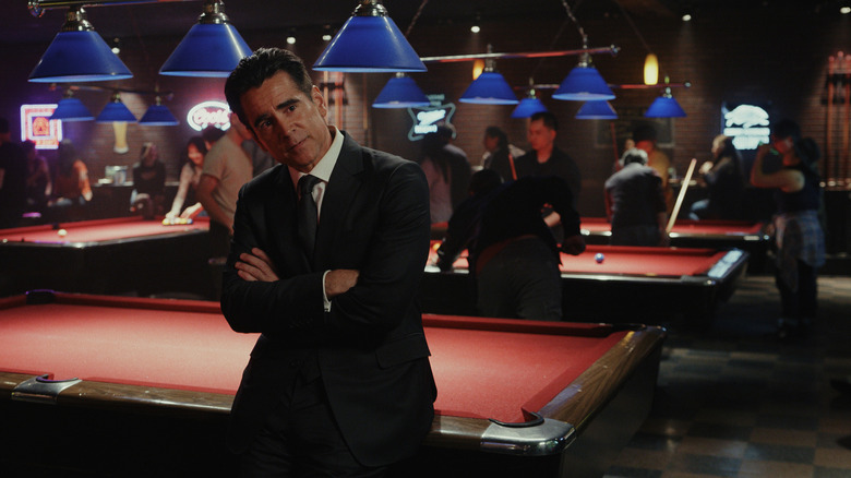 Colin Farrell as John Sugar leaning against a pool table in a crowded bar and crossing his arms in Sugar