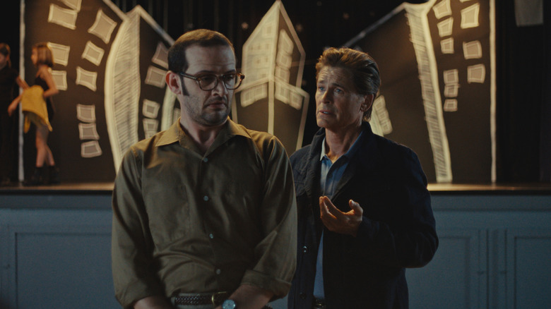 Will Brill and Rob Lowe as Doug and Principal Brady in front of a New York play set in The Musical