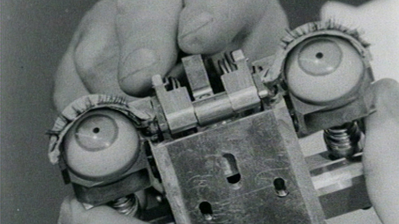 A close-up of mechanical eyes in black and white from Ghost in the Machine