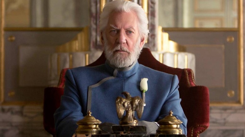 President Snow in military dress sitting in a chair in The Hunger Games: Mockingjay