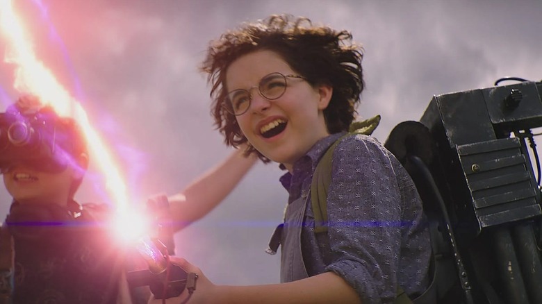 McKenna Grace as Phoebe Spengler firing a proton pack in Ghostbusters: Afterlife