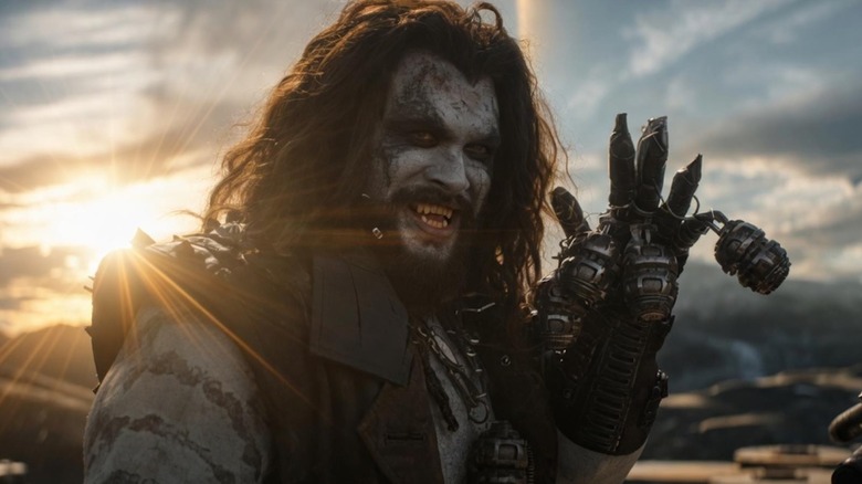 Lobo grinning while holding up his metal-plated arm in Supergirl (2026)