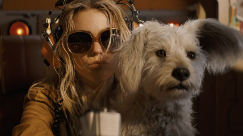 Milly Alcock as Kara Zor-El/Supergirl sitting with Krypto in Supergirl (2026)