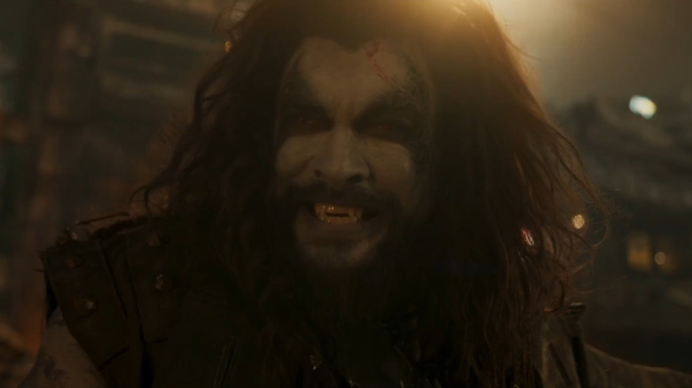Jason Momoa as Lobo grinning while riding his motorcycle in Supergirl