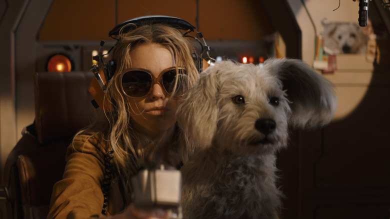 Kara and Krypto sit in the cockpit of her spaceship, staring ahead