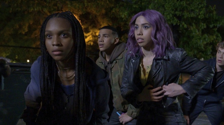 A group of teens huddle in fear