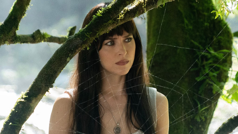 Cassie behind a web in the Amazon where her mother was researching spiders just before she died in Madame Web