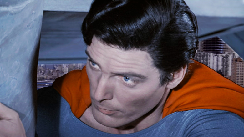 Christopher Reeve's Superman looks up while holding the Statue of Liberty in Superman IV: The Quest For Peace